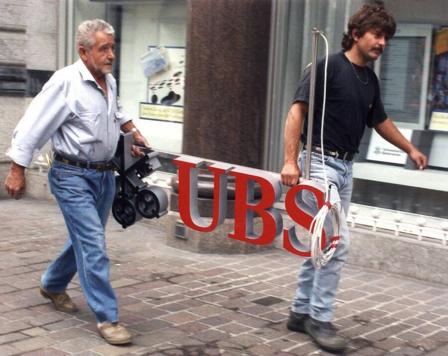 Arbeiter bereiten am 22. Juni 1998 die Montage des neuen Firmenschilds der UBS in St.Gallen vor. Rund ein halbes Jahr davor,  am 8. Dezember 1997, wurde die Fusion von SBG und Bankverein verkündet.  